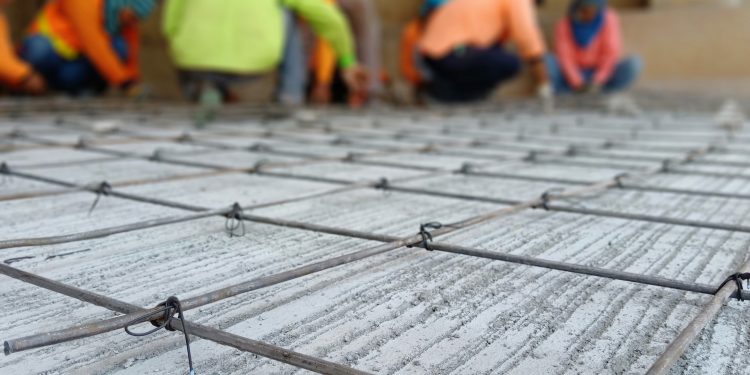 Binding work for steel reinforced concrete grating For road construction (blurred images)