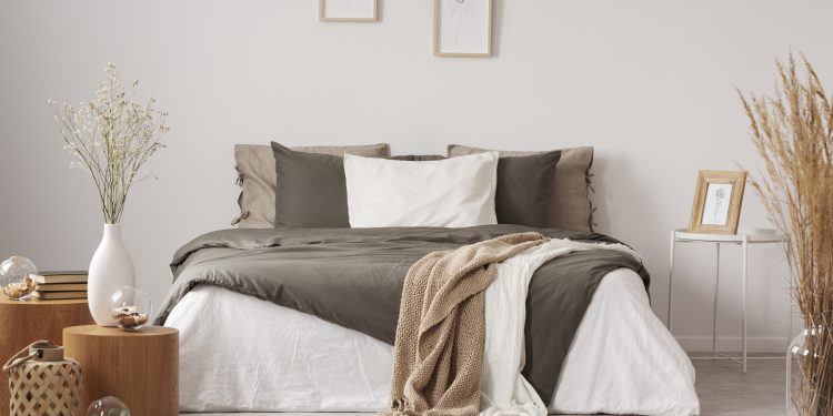 Spacious bedroom interior in beige and olive colour