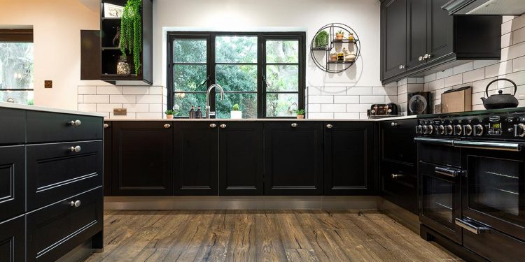 A kitchen with black cabinets Description automatically generated with medium confidence