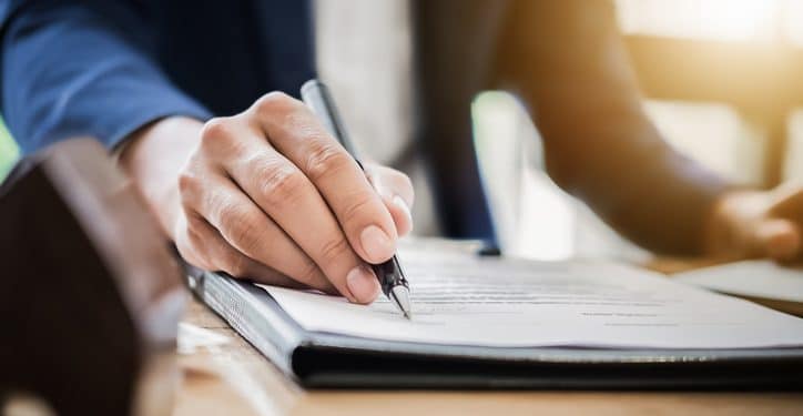 estate agent gives pen and documents agreement with customer to sign contract. Concept agreement