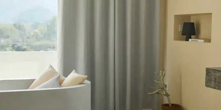 Want to create a feeling of privacy in your home without sacrificing style? You'll be surprised to learn just how easy it is. Investing in the right window treatments for your space can make all the difference between living within a fishbowl and having an oasis of peace and quiet. In this comprehensive guide, you'll find tips on what window treatments are best for achieving maximum privacy while adding beauty and value to your home decor. From blinds and shades to film applications, curtains, shutters, valances, drapes-and more-we've got a comprehensive guide on creating privacy with window treatments. Best Window Treatment Options for Privacy The need for privacy in your personal space is a fundamental aspect of human comfort and well-being. This is particularly true in urban areas where houses are often closely situated to each other, allowing little room for privacy. Luckily, the right window treatments can provide us with the privacy we need while adding an aesthetic touch to our homes. Referred to as the "eyes" of the home, windows can provide a beautiful view but also make us feel exposed if not properly dressed. That's where window treatments come into play. Let's delve into the best window treatments that ensure privacy without compromising on style. Roller Shades Roller shades are a popular choice for those seeking privacy. Available in a range of opacity levels, you can choose a fabric that suits your privacy needs and aesthetic preferences. This type of shade is easy to operate, often operated with a pull cord or a motorized system, and can be custom-made to fit any window size. Cellular Shades Cellular shades, also known as honeycomb shades, are recognized for their superior insulation qualities. However, they're also fantastic for privacy. The unique cellular construction allows natural light to filter into the room while keeping unwanted eyes out. They come in a range of colors and cell sizes, allowing for a custom fit for your windows. Roman Shades Roman shades are a stylish and practical choice for window privacy. They offer a clean and classic look that blends well with various decor styles. When lowered, Roman shades provide complete window coverage, ensuring maximum privacy. They're available in a range of fabrics, colors, and patterns, allowing you to personalize your space to your liking. Window Film If you're not a fan of traditional window treatments, window film applications are an excellent alternative. They provide total privacy while allowing plenty of natural light to pass through. Available in various designs and patterns, you can choose a film that complements your decor style. Shutters Shutters are a classic choice for those seeking maximum privacy with an elegant touch. They come in many styles, materials, and finishes, making it easy to find one that fits your home's aesthetic. They're also durable and low maintenance, making them a favorite among homeowners. Drapes For a luxurious touch of privacy, opt for drapes. You can choose from a variety of fabrics ranging from sheer to blackout options, depending on the level of privacy you want to achieve. Drapes not only provide exceptional privacy but also add a touch of elegance and sophistication to any room. Valances Valances are an excellent option for those who prefer to keep their windows unobstructed while still achieving some level of privacy. They're available in various fabrics, sizes, and styles, allowing you to customize them according to your preferences. Whether straight, scalloped, or arched, valances are a decorative and practical choice for privacy. Additional Tips for Achieving Privacy in Your Home Achieving a sense of seclusion and solitude in the comfort of your home is a delicate balance to strike, especially in bustling city environments. The right window treatment can make all the difference, but what can further enhance the room's privacy are some additional strategies. Implementing these suggestions and window treatments can help you create a perfect sanctuary in your urban dwelling. Use Layered Treatments Adding layered window treatments, such as a combination of sheer curtains and blackout drapes, not only adds to the aesthetic appeal but also enhances the privacy of your room. You can adjust the layers as needed based on the time of day and your privacy requirements. Install Top-Down Bottom-Up Shades These shades are exceptionally versatile and offer a unique solution to privacy problems. They allow you to lower the top half while keeping the bottom half covered, enabling natural light to enter the room without compromising privacy. Try Frosted Glass For those who want to maintain a sleek, modern look while ensuring privacy, frosted glass can be an ideal solution. It lets in light but obscures the view, making it an ideal choice for bathrooms or ground-level windows. Consider Outside Landscaping Planting trees or adding structures like trellises or fences can also improve privacy. Not only do these additions provide a natural cover for your windows, but they also enhance the overall aesthetic appeal of your home exterior. Use Room Dividers If your room has large windows or glass walls, using room dividers can create an extra layer of privacy. This can also help you divide the space into different functional areas, adding to the overall efficiency of your room. Opt for Smart Glass Smart glass, or switchable glass, is an innovative material that changes its opacity with the flick of a switch. You can switch them from clear to frosted, providing instant privacy whenever needed. Though more of an investment, this state-of-the-art solution offers the perfect blend of modernity and privacy. Final Thoughts Whether you're trying to escape the busy city life or simply want some solitude in your home, privacy is essential. With these window treatment options and additional strategies, you can create a comfortable and private sanctuary in your urban dwelling. Remember to choose a style that suits your needs and aesthetic preferences, as well as implement additional tips for maximum seclusion. Click here to get in touch with a window treatment expert and schedule your consultation.